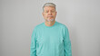 © Krakenimages.com - Portrait of a grey-haired man in casual attire against a white background looking at the camera.