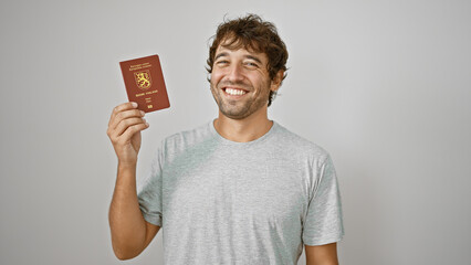 Wall Mural - Happy, confident young blond man enjoying his finnish passport, smiling big on isolated white background â€“ the joyful, casual guy all set for his euro-trip