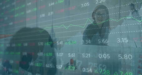 Poster - Image of stock market data processing over caucasian businesswoman using laptop at office