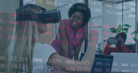 Poster - Image of stock market data processing over two diverse women wearing vr headset at office