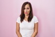 © Krakenimages.com - Middle age brunette woman standing over pink background depressed and worry for distress, crying angry and afraid. sad expression.