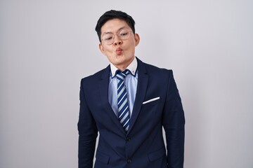 Sticker - Young asian man wearing business suit and tie making fish face with lips, crazy and comical gesture. funny expression.