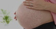 Dna strand over midsection of pregnant caucasian woman touching belly
