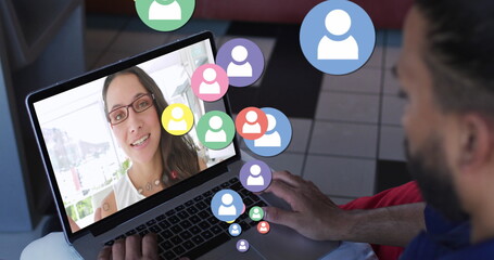 Poster - Image of profile icons floating against rear view of biracial man having a image call on laptop