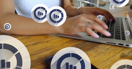 Wall Mural - Image of graph icon in circles over midsection of caucasian woman working on laptop