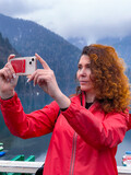Fototapeta Sypialnia - woman with smartphone taking selfie
