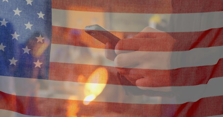 Poster - Image of American flag waving over man using phone in the background
