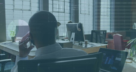 Poster - Image of data processing over african american businessman talking on smartphone in office