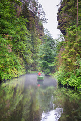 Summer natural landscape - view of the river with a boatman in the Elbe Sandstone Mountains, Bohemian Switzerland, the north-western Czech Republic