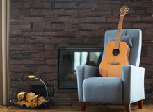 Cozy Living Room With Guitar On The Armchair