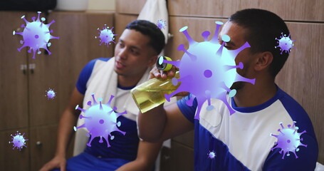 Poster - Image of covid-19 cells icons over hispanic male soccer player putting water on his face