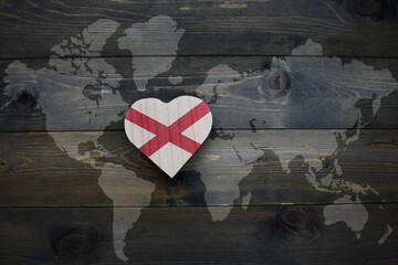 Wall Mural - wooden heart with national flag of alabama state near world map on the wooden background.