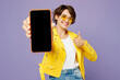 Young woman wears yellow shirt white t-shirt casual clothes glasses hold use blank screen workspace area mobile cell phone show thumb up isolated on plain pastel purple background. Lifestyle concept.