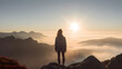 © photo for everything - Back view of woman female standing on the cliff, watching sunrise breathtaking and enjoy it.