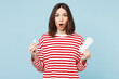 Young shocked surprised woman wear red casual clothes hold in hand choose tampon and sanitary napkin look camera isolated on plain blue background Medical gynecological, pms menstruation days concept