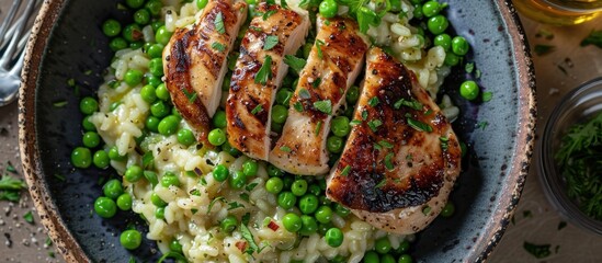 Poster - A top-down view of a plate containing delicious chicken, rice, and green peas, nicely arranged and ready to be enjoyed.