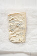 Slice of Lombard cheese, known as Stracchino or Gorgonzola. Italian food.