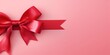 Red ribbon with bow on pink background, Christmas card concept. Space for text. Red and Pink Background