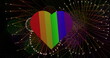 Image of pride rainbow heart and fireworks exploding on black background