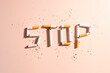 World no tobacco day concept template. Flat layout of STOP text made from cigarette or tobacco on brown background.