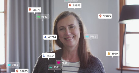 Poster - Image of social media text and icons over caucasian woman at home