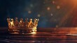 low key image of a beautiful gold crown on a wooden table vintage filtered photograph