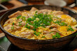 Authentic Simmering Oyakodon in Traditional Japanese Donburi Pan: A Glimpse into Cultural Cuisine