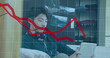 Image of multiple falling graphs over asian boy playing game on digital tablet