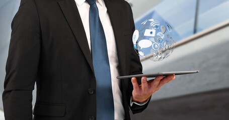 Poster - Image of a globe, icons and connection network spinning while a young Caucasian businessman is using