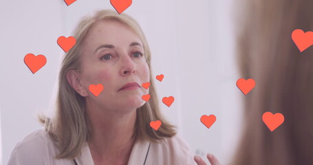 Poster - Image of hearts over caucasian woman looking in mirror