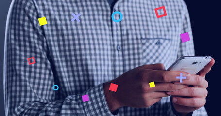 Poster - Abstract colorful shapes against mid section of man using a smartphone
