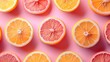 Colorful top view of sliced citrus fruits on a vibrant pink backdrop