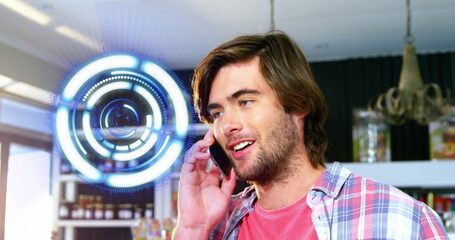 Poster - Image of spinning round scanner over portrait of caucasian talking on smartphone at a cafe