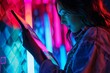 App preview over shoulder of a woman holding a tablet with a fully neon screen