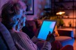 © Markus Schröder - Device screen seen from a shoulder of a senior citizen woman holding a tablet with a fully neon screen