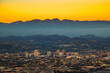 Sunset above downtown Glendale and San Gabriel Mountains in background viewed from Griffith Park near Los Angeles, California.