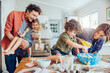 © Marko Geber - Happy family baking together in the kitchen