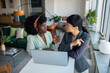 © Marko Geber - Two young businesswomen discussing work over laptop in office