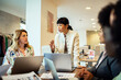 © Marko Geber - Diverse female business team working and smiling at office desk with laptop