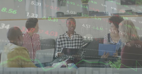 Canvas Print - Image of trading board over diverse colleagues discussing report in meeting at office