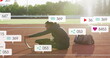 Image of notification bars over african american athlete performing stretching on race track