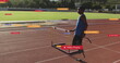 Image of notification bars over african american athlete performing stretching holding hurdle