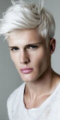 Canvas Print - A young man with white hair and blue eyes.