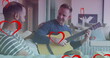 Image of heart icons over diverse gay couple smiling and playing guitar
