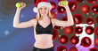 Image of caucasian sportswoman and baubles over snow falling