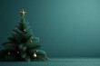 A Christmas tree with a gold star on top stands in front of a green wall, empty space, background