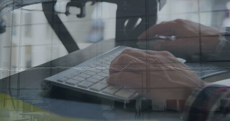 Canvas Print - The hands of a young caucasian male business creative are shown typing on a computer keyboard and mo