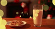 Image of dots moving over milk and cookies for santa claus