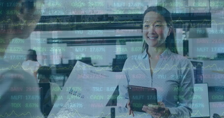 Poster - Image of trading board over diverse coworkers discussing reports on digital tablet in office