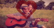 Image of red heart over couple in love with guitar